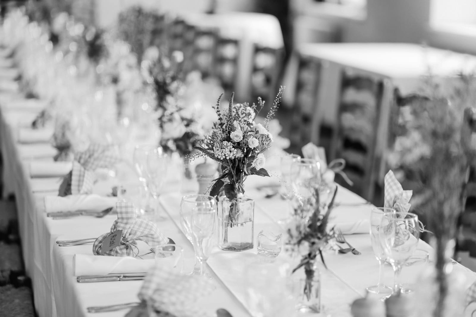 Bud vases and florals styled along a shower table